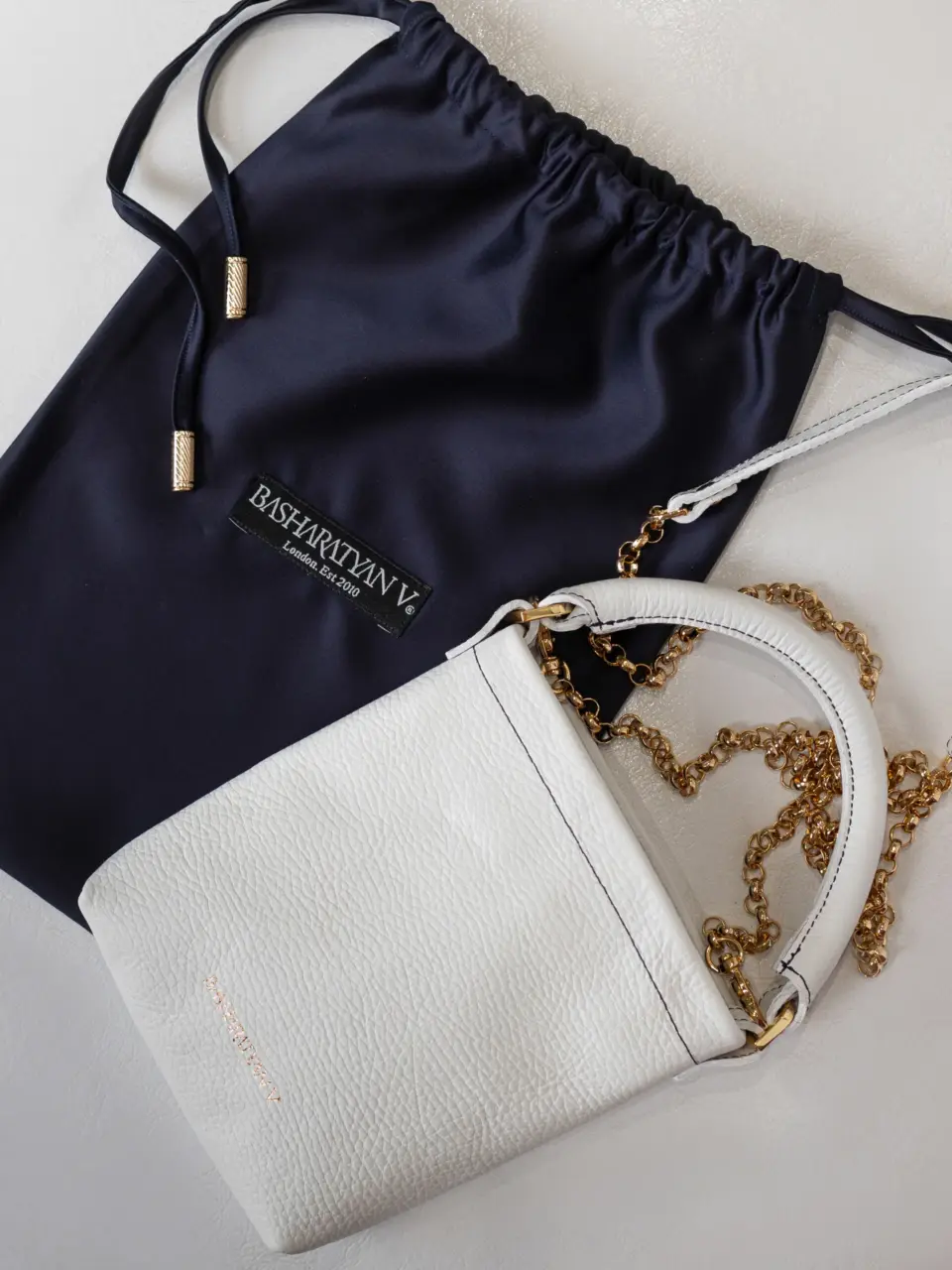Mini pochette in white with gold detailing